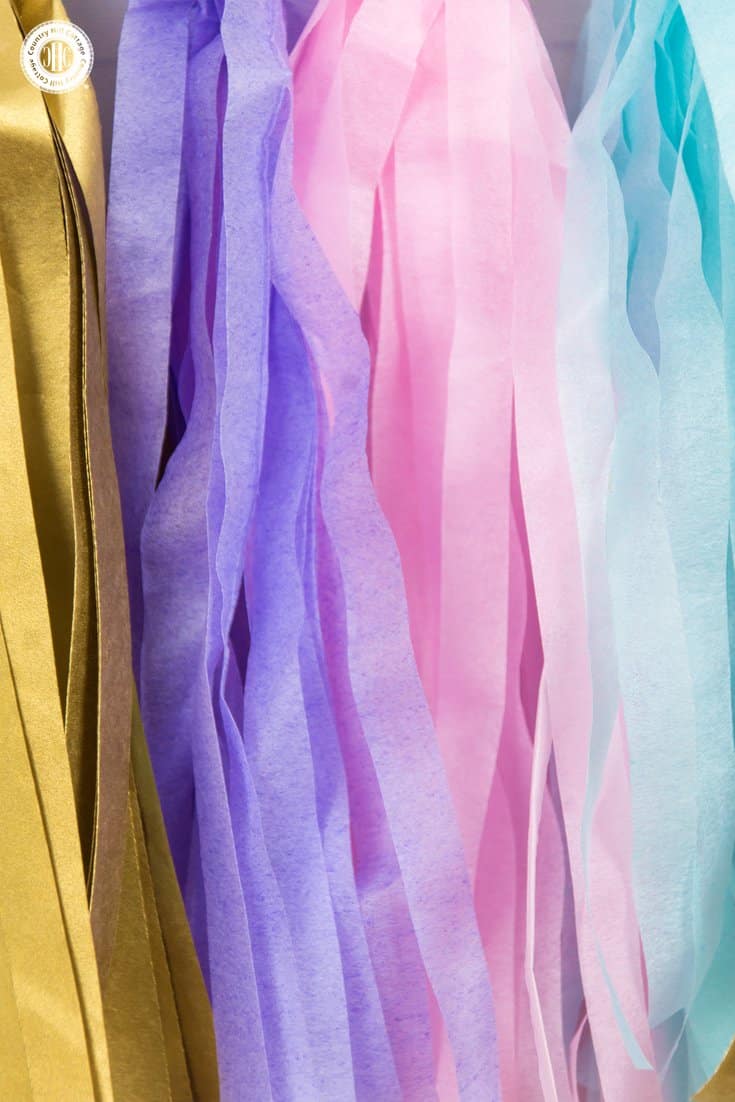 Learn to craft a beautiful tassel garland in 4 easy steps made from tissue paper. This garland looks great as decoration for parties, wedding receptions, and dessert tables. #papercrafts #tissuepaper #paperdecor | countryhillcottage.com