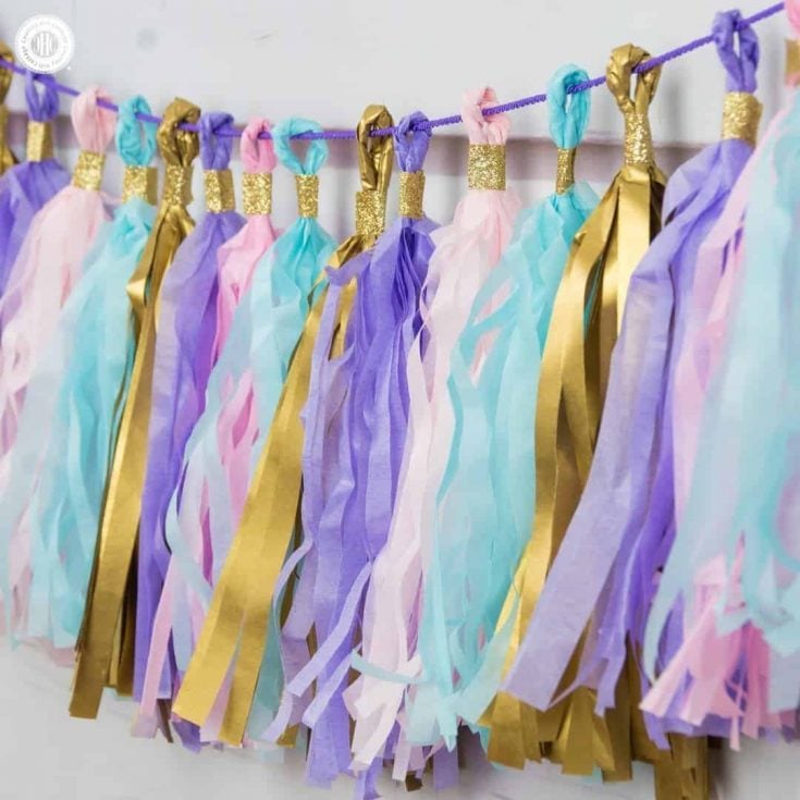 Learn to craft a beautiful tassel garland in 4 easy steps made from tissue paper. This garland looks great as decoration for parties, wedding receptions, and dessert tables. #papercrafts #tissuepaper #paperdecor | countryhillcottage.com