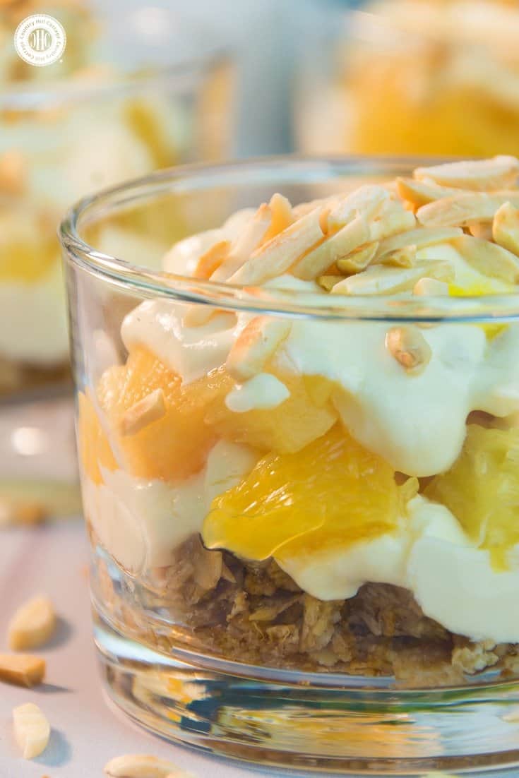 Our mango orange pineapple trifle is made of delicious layers of crushed granola, roasted almonds, fresh pineapple, mango sauce and creamy clotted cream. It tastes both luxurious and creamy, as well as fruity and airy! #dessert #recipe #trifle | countryhillcottage.com