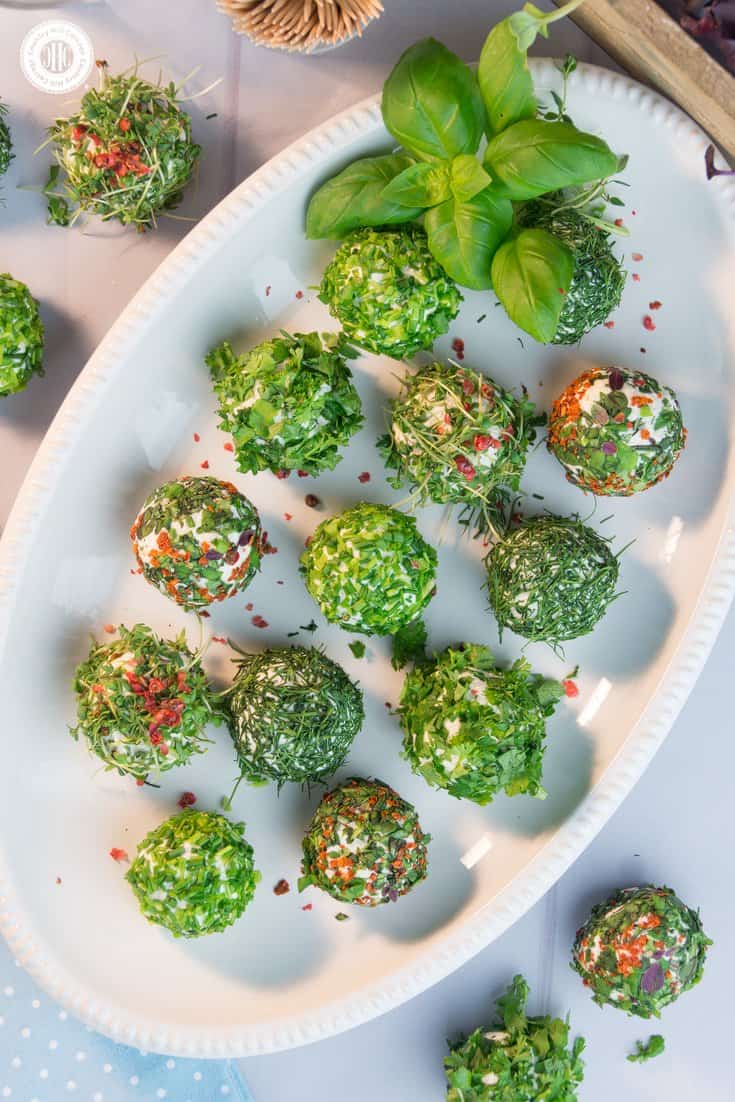 Start off a light summer meal or party with delicious herb-coated cheese balls. The foundation of this mouthwatering and quick-to-make appetiser is made with four different types of cheese that highlight the flavours of the fresh herbs, such as parsley, chives, dill and cress. #herbs #cheese #appetiser | countryhillcottage.com