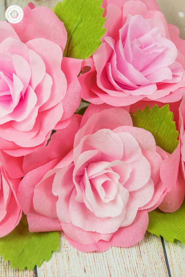 Learn how to make romantic crepe paper roses. These handcrafted beauties are very long lasting and wonderful for home decorating, in paper flower arrangements and wedding decor. We created a printable template to make cutting the petals and leaves as easy as possible. #diy #paperflowers #crepepaper #paperroses| countryhillcottage.com