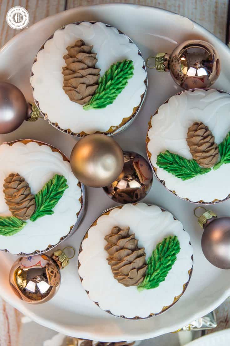 Indulge in Christmas flavours with our delicious honey almond cupcakes! The cupcakes are made with honey-roasted almonds, a generous pinch of cinnamon, and cream cheese to keep them moist. We decorate the cupcakes with edible pine cones and spruce branches. #Christmas #cupcakes #recipe | countryhillcottage.com Indulge in Christmas flavours with our delicious honey almond cupcakes! The cupcakes are made with honey-roasted almonds, a generous pinch of cinnamon, and cream cheese to keep them moist. We decorate the cupcakes with edible pine cones and spruce branches. #Christmas #cupcakes #recipe | countryhillcottage.com