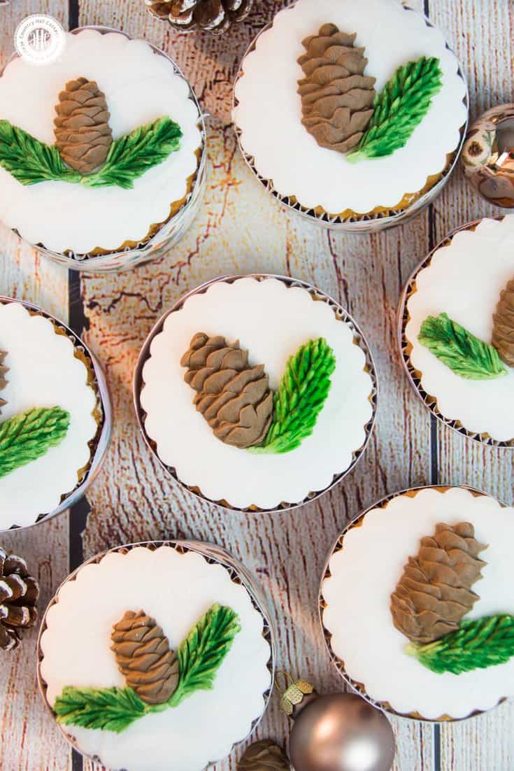 Indulge in Christmas flavours with our delicious honey almond cupcakes! The cupcakes are made with honey-roasted almonds, a generous pinch of cinnamon, and cream cheese to keep them moist. We decorate the cupcakes with edible pine cones and spruce branches. #Christmas #cupcakes #recipe | countryhillcottage.com Indulge in Christmas flavours with our delicious honey almond cupcakes! The cupcakes are made with honey-roasted almonds, a generous pinch of cinnamon, and cream cheese to keep them moist. We decorate the cupcakes with edible pine cones and spruce branches. #Christmas #cupcakes #recipe | countryhillcottage.com