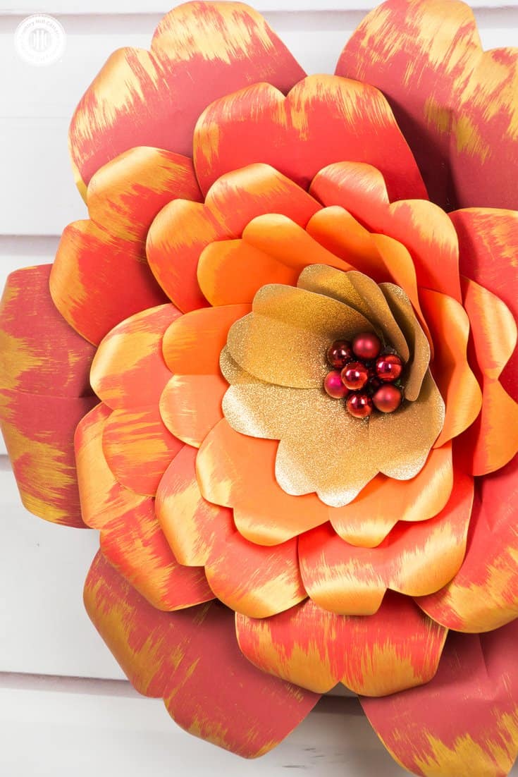 Learn how to make giant red and gold paper flowers! We worked with vibrant shades of cardstock for the petals, ranging from dark red to deep orange, as well as gold glitter paper, and embellished the edges of the petals with gold accents. We used mini bauble ornaments to create the flower centre and to give the flower an elegant finish. You can download the free printable templates we used to make the flowers at our blog. #paperflowers #template #papercrafts | countryhillcottage.com