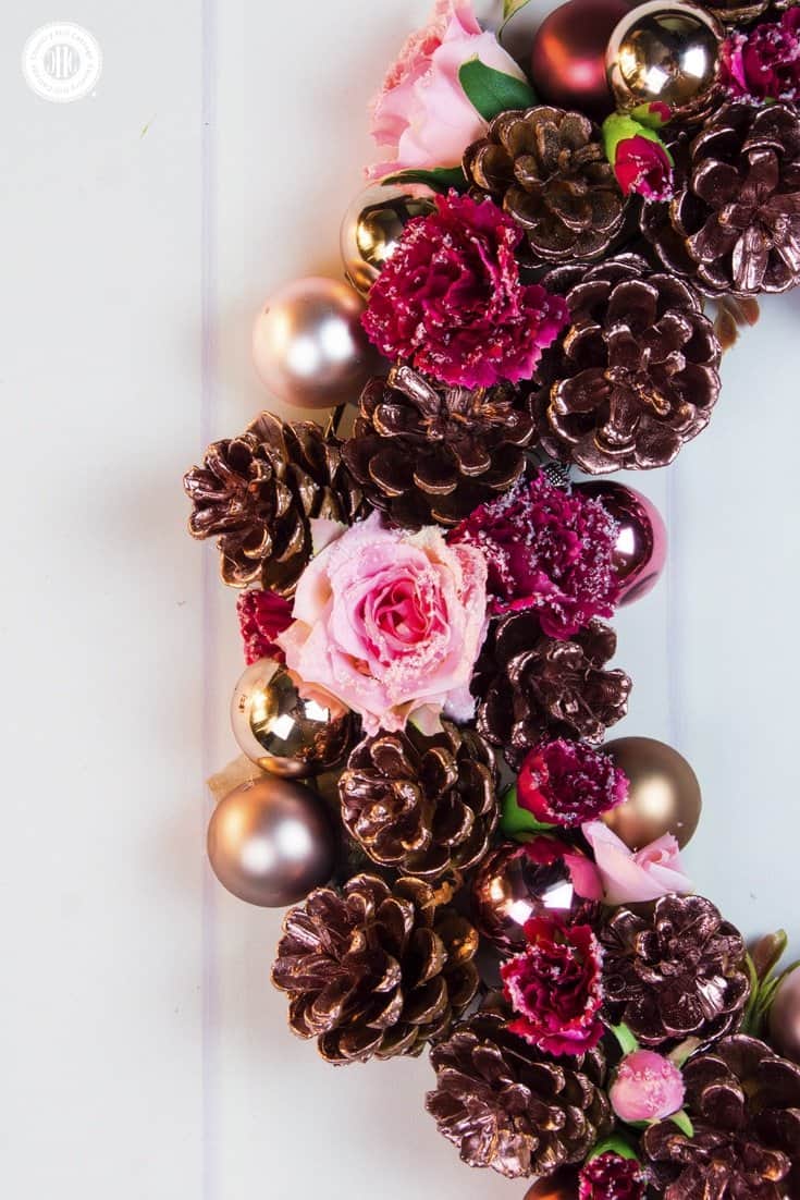 Our romantic rose gold pinecone wreath is such a simple and fun way to add some style to your home this holiday season. All you need are some pinecones, silk flowers, mini bauble ornaments, and rose gold spray paint your good to craft! #Christmas #flowerarranging #wreath | countryhillcottage.com Our romantic rose gold pinecone wreath is such a simple and fun way to add some style to your home this holiday season. All you need are some pinecones, silk flowers, mini bauble ornaments, and rose gold spray paint your good to craft! #Christmas #flowerarranging #wreath | countryhillcottage.com