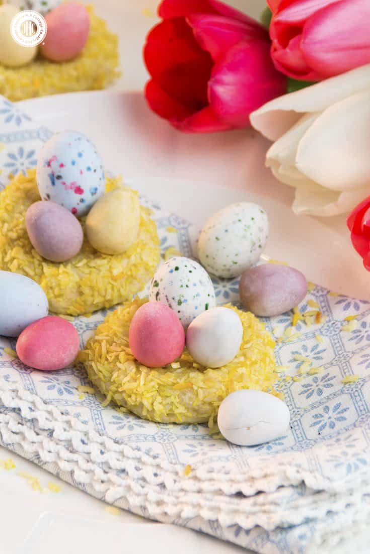 Easter nest cookie are a sweet treat for spring and Easter. . They consist of delicious cookie dough, rolled in coconut and stuffed with mini candy eggs. This recipe is great to do with kids. #Easter #spring #biscuits #cookies #bunnybiscuits #Easternest #Eastercookies #recipe #foodgift #giftgiving | countryhillcottage.com