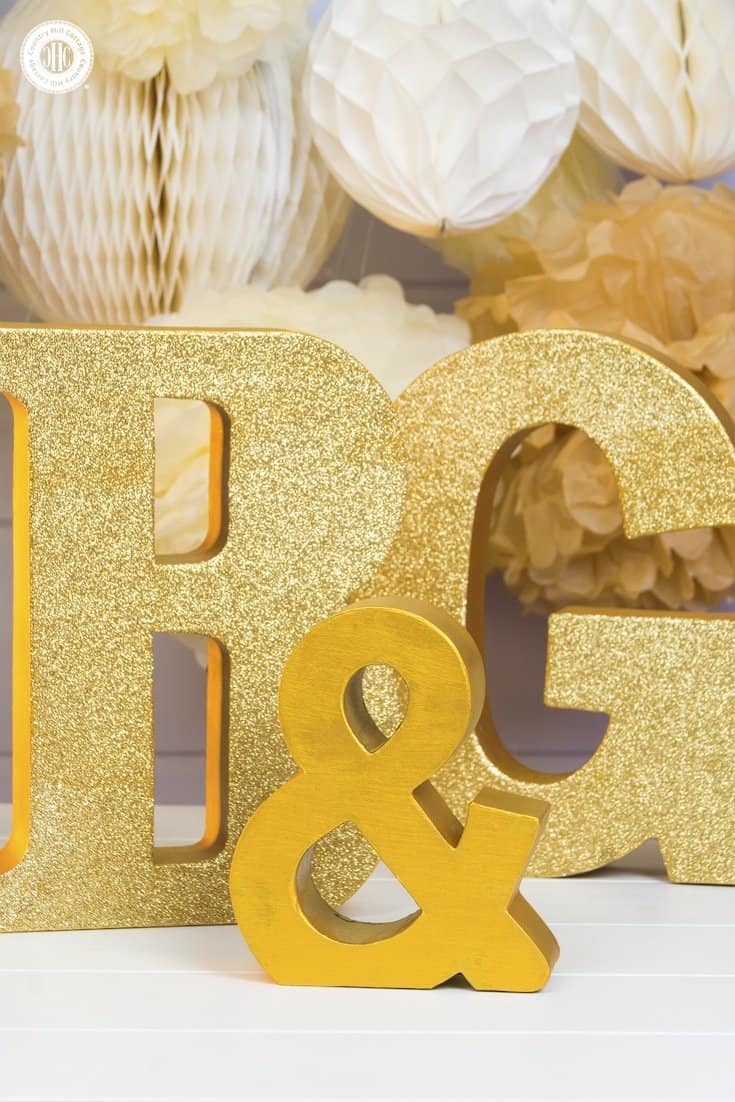 Learn how to how glitter wedding letters! We use large paper mache letters and show different techniques to paint the letters, apply glitter and decorate them with silk flowers. Monogram letters make fabulous wedding décor to display the initials of the bride and groom. You can use them as table decoration or hang them as a wall ornament. #diy #wedding #decor #glitter #monogram | countryhillcottage.com Learn how to make glitter wedding letters! We use large paper mache letters and show different techniques to paint the letters, apply glitter and decorate them with silk flowers. Monogram letters make fabulous wedding décor to display the initials of the bride and groom. You can use them as table decoration or hang them as a wall ornament. #diy #wedding #decor #glitter #monogram | countryhillcottage.com