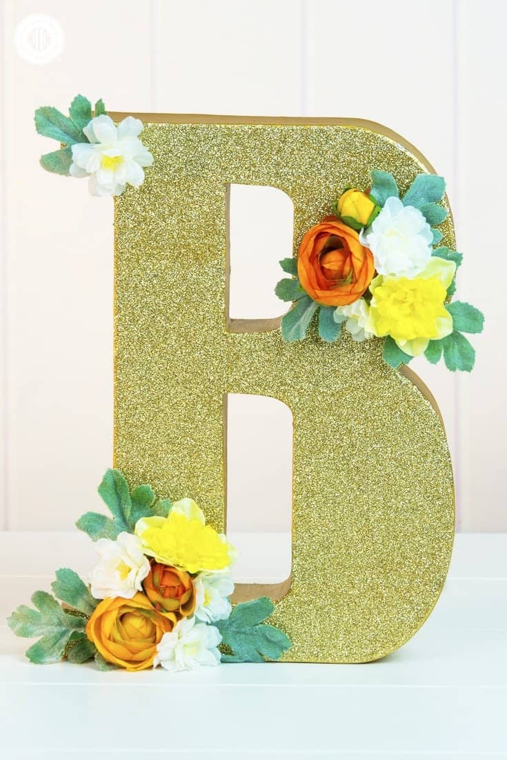 Learn how to make glitter wedding letters! We use large paper mache letters and show different techniques to paint the letters, apply glitter and decorate them with silk flowers. Monogram letters make fabulous wedding décor to display the initials of the bride and groom. You can use them as table decoration or hang them as a wall ornament. #diy #wedding #decor #glitter #monogram | countryhillcottage.com Learn how to make glitter wedding letters! We use large paper mache letters and show different techniques to paint the letters, apply glitter and decorate them with silk flowers. Monogram letters make fabulous wedding décor to display the initials of the bride and groom. You can use them as table decoration or hang them as a wall ornament. #diy #wedding #decor #glitter #monogram | countryhillcottage.com