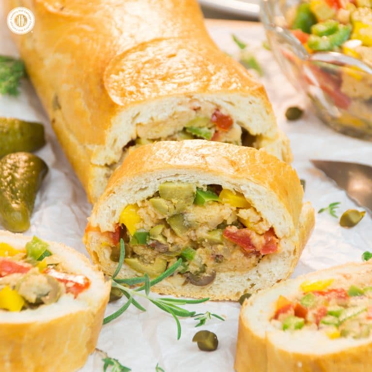 Ready for a new take on sandwiches? Then try Patafla, a delicious Mediterranean picnic loaf! Patafla is made with a French loaf (sounds scrumptious already, right?), and stuffed with a colourful summer veggie filling. Aside from being a terrific addition to your picnic basket, patafla also is a great party appetiser to feed a large crowd. #patafla #picnic #sandwich #recipe #tomatoes #peppers | countryhillcottage.com