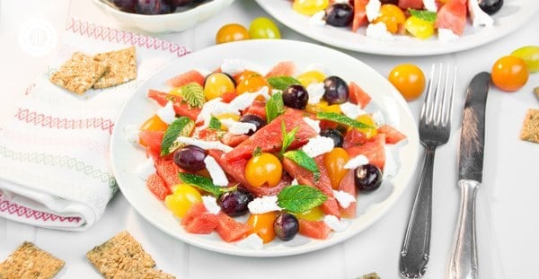 This quick and colourful watermelon salad is packed with fresh fruits and perfect to cool down on hot summer evenings. Aside from juicy watermelon slices, the recipe includes mozzarella cheese, cherry tomatoes and blue grapes, which add a burst of deep, rich sweetness. A lime vinaigrette with grapeseed oil adds zest to this light salad, while fresh mint leaves bring a fresh kick throughout. #watermelonsalad #watermelon #salad #grapes #mint #summersalad| countryhillcottage.com This quick and colourful watermelon salad is packed with fresh fruits and perfect to cool down on hot summer evenings. Aside from juicy watermelon slices, the recipe includes mozzarella cheese, cherry tomatoes and blue grapes, which add a burst of deep, rich sweetness. A lime vinaigrette with grapeseed oil adds zest to this light salad, while fresh mint leaves bring a fresh kick throughout. #watermelonsalad #watermelon #salad #grapes #mint #summersalad| countryhillcottage.com