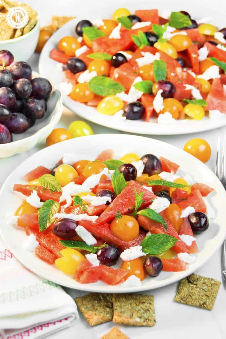 This quick and colourful watermelon salad is packed with fresh fruits and perfect to cool down on hot summer evenings. Aside from juicy watermelon slices, the recipe includes mozzarella cheese, cherry tomatoes and blue grapes, which add a burst of deep, rich sweetness. A lime vinaigrette with grapeseed oil adds zest to this light salad, while fresh mint leaves bring a fresh kick throughout. #watermelonsalad #watermelon #salad #grapes #mint #summersalad| countryhillcottage.com