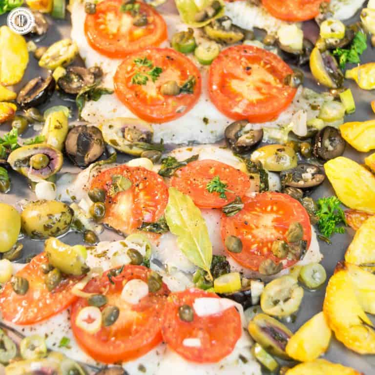 Baked Dover sole and veggies sheet pan combines two summer favourites: Dover sole and new potatoes. Dover sole is delicate in taste and texture and pairs perfectly with the aroma of juice tomatoes, spring onions, capers, olives, and fresh herbs. New potatoes are cut into wedges and pan-roasted as well. The recipe takes less than 1 hour, perfect for a quick midweek meal. It’s also a great course of a light summer dinner. #sheetpandish #doversole #sole #fish #tomatoes| countryhillcottage.com