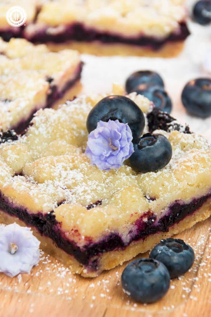 For a bite of pure bliss, sink your teeth into delicious blueberry streusel bars! Layers of crumbly streusel and sweet blueberry filling add up to a scrumptious bar cookie. The steps are incredibly simple, making it an easy-enough bake to get your kids involved. Instead of blueberries, you can also prepare the squares with frozen raspberries, blackberries, or quartered cherries. #blueberries #streusel #bars #bakingrecipe | countryhillcottage.com For a bite of pure bliss, sink your teeth into delicious blueberry streusel bars! Layers of crumbly streusel and sweet blueberry filling add up to a scrumptious bar cookie. The steps are incredibly simple, making it an easy-enough bake to get your kids involved. Instead of blueberries, you can also prepare the squares with frozen raspberries, blackberries, or quartered cherries. #blueberries #streusel #bars #bakingrecipe | countryhillcottage.com
