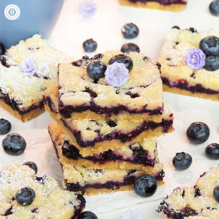 For a bite of pure bliss, sink your teeth into delicious blueberry streusel bars! Layers of crumbly streusel and sweet blueberry filling add up to a scrumptious bar cookie. The steps are incredibly simple, making it an easy-enough bake to get your kids involved. Instead of blueberries, you can also prepare the squares with frozen raspberries, blackberries, or quartered cherries. #blueberries #streusel #bars #bakingrecipe | countryhillcottage.com