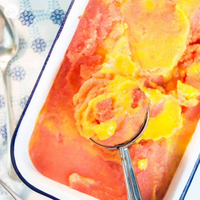 Stay cool with scoops of refreshing and healthy watermelon mango sorbet! Watermelon and mango are a wonderful flavour combination and the sorbet is super easy to prepare. This frozen treat is vegan, and you only need two ingredients to whip up a batch. No ice cream maker is required just fresh or frozen water melon and mango chunks. #mango #watermelon #sorbet #icecream | countryhillcottage.com