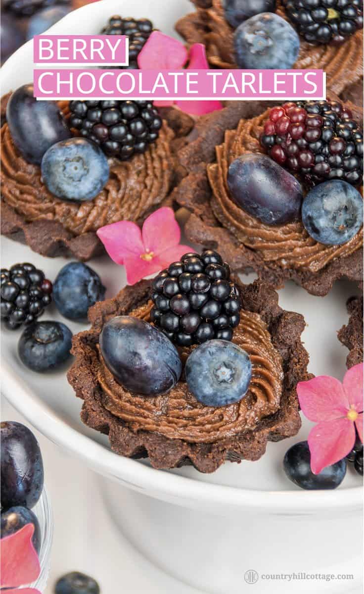 For a lovely afternoon tea indulgence bake delicious chocolate tartlets with berries! Crisp chocolate shells are laden with dark summer berries and filled with a delectable chocolate cream cheese filling with subtle berry notes. The dough is soft, crumbly and has an intense chocolate flavour. The soft filling is made with cream cheese, white and dark chocolate and blueberry jam to reflect the berry decoration. #tartlet #chocolate #tart #berries #bakingrecipe | countryhillcottage.com For a lovely afternoon tea indulgence bake delicious chocolate tartlets with berries! Crisp chocolate shells are laden with dark summer berries and filled with a delectable chocolate cream cheese filling with subtle berry notes. The dough is soft, crumbly and has an intense chocolate flavour. The soft filling is made with cream cheese, white and dark chocolate and blueberry jam to reflect the berry decoration. #tartlet #chocolate #tart #berries #bakingrecipe | countryhillcottage.com