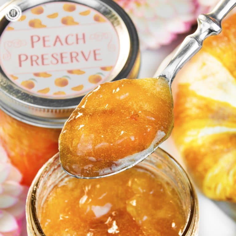 Delicious peach preserves are syrupy and soft-set with juicy peach chunks throughout. This homemade peach jam tastes scrumptious slathered on scones and hot toast, stirred into yoghurt, or as filling for cakes and pastries. The jars also make sweet additions for gift hampers or a hostess gift for a brunch or luncheon. The recipe comes with printable labels for gift giving. #peachjam #peachpreserves #peaches #jam #preserves | countryhillcottage.com