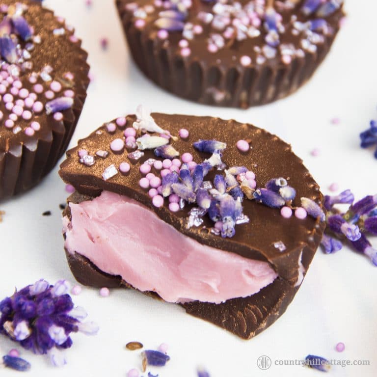 Lavender chocolate truffles are the perfect blend of rich dark chocolate and luxurious lavender aroma. The first step is to whip up a lavender-infused chocolate ganache. Then layer melted dark chocolate and the ganache in small cupcake cases and chill until set. These indulgent little chocolate cups are great homemade food gift for many occasions. Tab the image for the recipe and free printable gift boxes. #chocolatetruffles #lavender #essentialoil #truffles #foodgifts | countryhillcottage.com