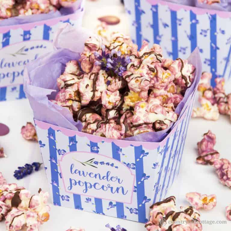 Lavender popcorn puts a floral spin on classic sweet popcorn. This sweet treat is made by coating fluffy popcorn in candy melts seasoned with lavender essential oil, followed by a drizzle of dark and white chocolate. You can prepare the recipe with homemade or store-bought, unflavoured or slightly salty or sweet popcorn. The recipe comes with a free printable popcorn box to package the popcorn for gift giving. #popcorn #lavender #essentialoil #lavenderpopcorn #foodgifts | countryhillcottage.com