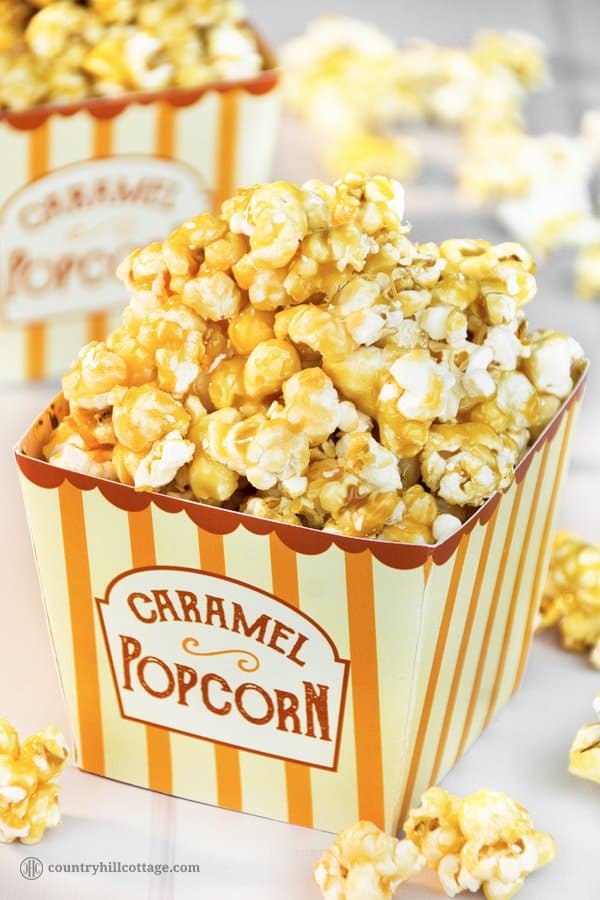 Homemade caramel popcorn is sweet, crunchy and hard to stop eating! This yummy snack is easy to whip up: pop the kernels or use premade popcorn. Then cook a thick caramel sauce with brown sugar and butter and toss the popcorn in the sauce. The recipe includes a printable retro popcorn box for gift giving or to serve at your next movie. Check out the recipe and learn how to make caramel popcorn from scratch. #caramelpopcorn #caramel #popcorn #foodgifts | countryhillcottage.com Homemade caramel popcorn is sweet, crunchy and hard to stop eating! This yummy snack is easy to whip up: pop the kernels or use premade popcorn. Then cook a thick caramel sauce with brown sugar and butter and toss the popcorn in the sauce. The recipe includes a printable retro popcorn box for gift giving or to serve at your next movie. Check out the recipe and learn how to make caramel popcorn from scratch. #caramelpopcorn #caramel #popcorn #foodgifts | countryhillcottage.com