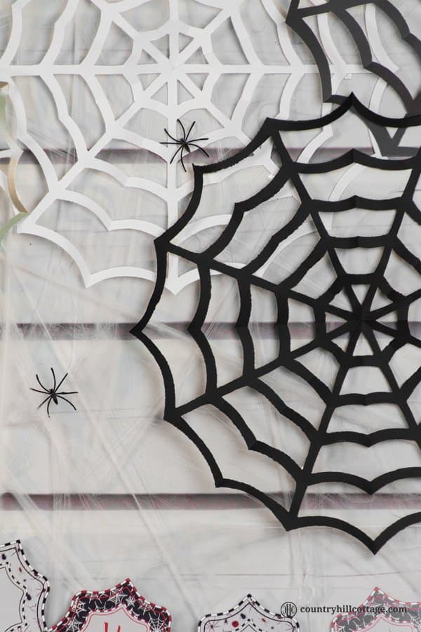 Paper spider webs add super spooky vibes to your home or classroom! DIY cobwebs look great as wall ornament, front door or window ornament, party décor and photo backdrop. All you need for this Halloween craft is paper, pencils, and craft scissors. This is a great DIY project to make with kids and an easy teacher Halloween craft for the classroom. Included are a free printable template and instructions. #DIY #spiderweb #Halloween #papercrafts | countryhillcottage.com
