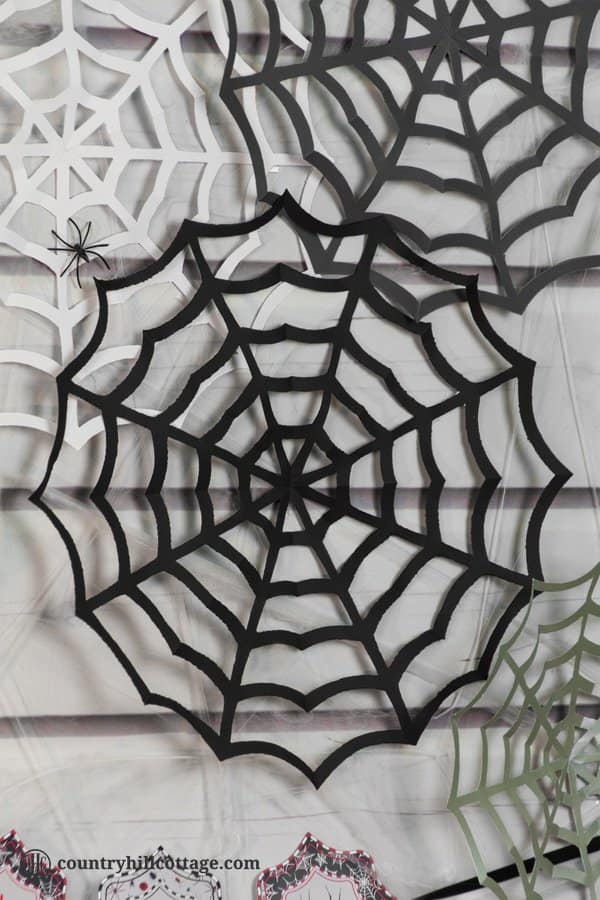 Paper spider webs add super spooky vibes to your home or classroom! DIY cobwebs look great as wall ornament, front door or window ornament, party décor and photo backdrop. All you need for this Halloween craft is paper, pencils, and craft scissors. This is a great DIY project to make with kids and an easy teacher Halloween craft for the classroom. Included are a free printable template and instructions. #DIY #spiderweb #Halloween #papercrafts | countryhillcottage.com