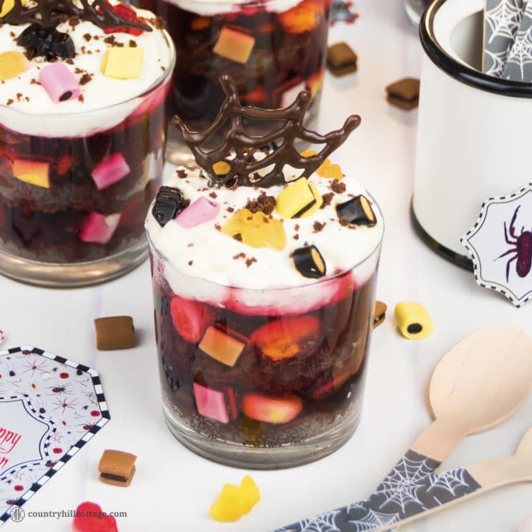 Chocolate cake, jelly, sweets, and whipped cream make for wicked layers in our second recipe, Tarantula Trifle. This quick and easy Halloween dessert include mostly store-bought goodies so that you can have the trifle on the table in almost no time. The trifle will be a sure crowd pleaser at your Halloween party. Plus, we also show how to make fun chocolate spider webs with our free printable template. #Halloween #trifle #Halloweendessert #dessert | countryhillcottage.com