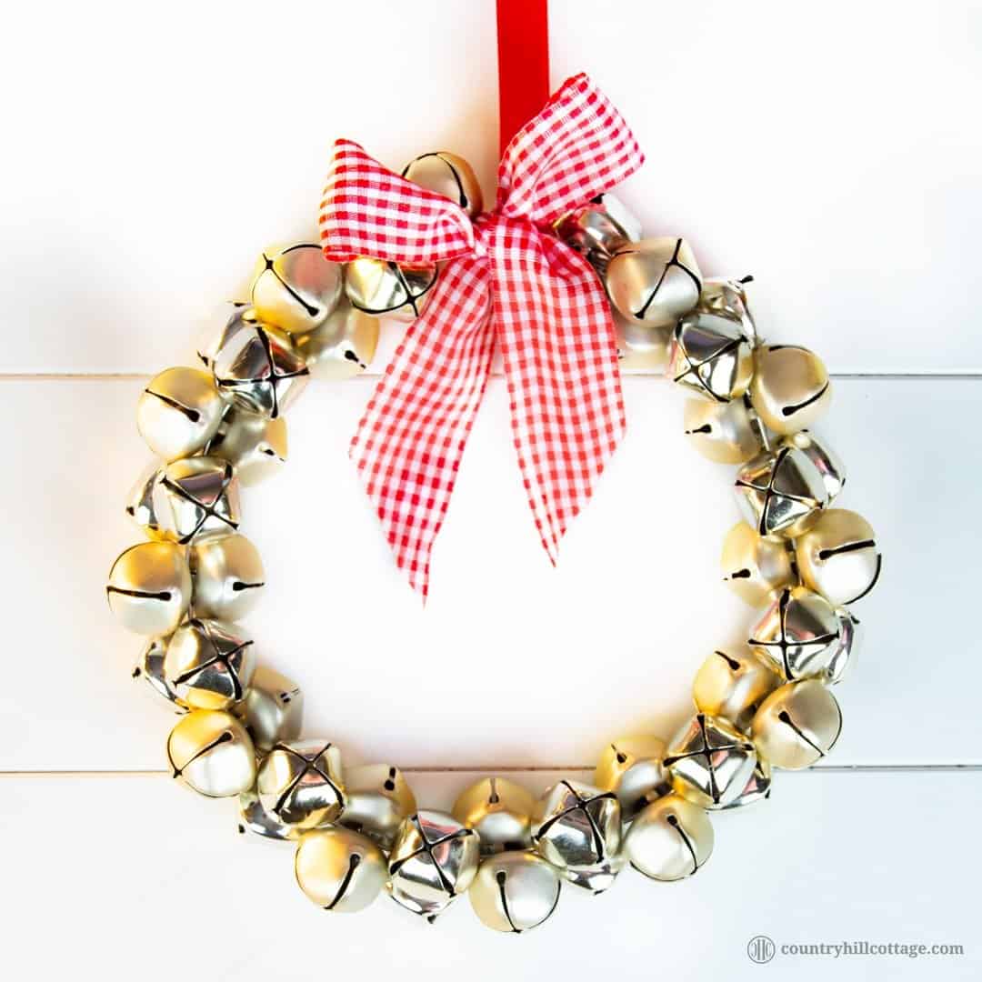 Show off your festive spirit and learn to make an easy and quick jingle bell wreath. This pretty DIY Christmas wreath adds festive touches to your front door, mantle or party décor! You only need a handful of bells, a piece of sturdy wire, ribbon and not more than five minutes to create this beautiful homemade craft holiday wreath. You can use the jingle bells wreath as Christmas door decoration or wall ornament. #wreath #ChristmasWreath #HolidayWreath #Christmas | countryhillcottage.com Show off your festive spirit and learn to make an easy and quick jingle bell wreath. This pretty DIY Christmas wreath adds festive touches to your front door, mantle or party décor! You only need a handful of bells, a piece of sturdy wire, ribbon and not more than five minutes to create this beautiful homemade craft holiday wreath. You can use the jingle bells wreath as Christmas door decoration or wall ornament. #wreath #ChristmasWreath #HolidayWreath #Christmas | countryhillcottage.com