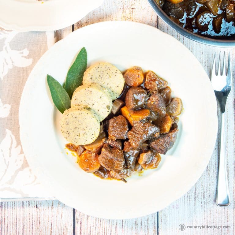 This easy beef stew recipe makes a sumptuous supper and is perfect for cheaper cuts. Our traditional braised beef stew is made with root veggies, fresh herbs, red wine and tasty broth. A slow cooking time guarantees tender meat and a flavourful gravy. The recipe includes instructions for cooking the beef stew on a stove top, in the oven or slow cooker, as well as tips for the type of beef cut you need, seasoning and other ingredients. #beef #stew #beefstew #stewrecipe | countryhillcottage.com