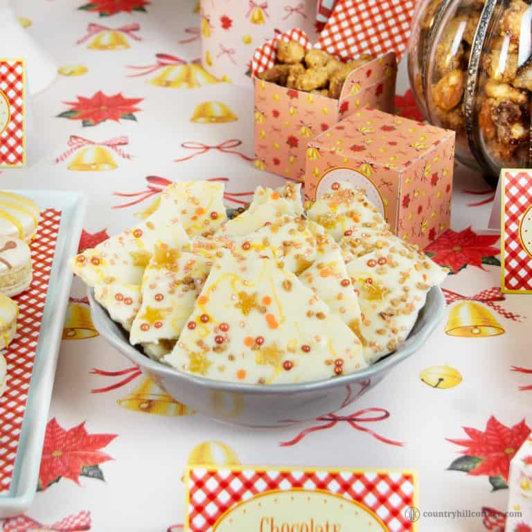 Christmas chocolate bark is a scrumptious sweet gift for anyone and great for holiday parties. This homemade holiday bark is totally doable in under one hour so that you can whip up a batch even last-minute. You don’t have to be a candy expert to make this treat. Just melt, pour, and decorate away. Easy and perfect to make with kids. We made our Christmas bark with crytsalised ginger, candied nuts, and cute sprinkles. #chocolatebark #candybark #chocolate #foodgift | countryhillcottage.com