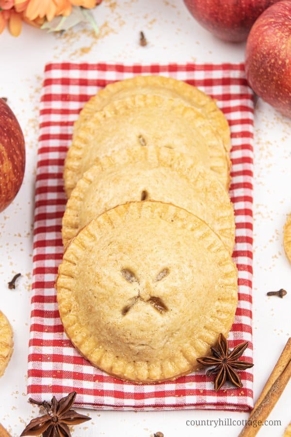Easy apple hand pies recipe from scratch! See how to make apple hand pies with a simple vegan gluten-free cinnamon pie crust and a flavorful caramel apple filling. These simple fruit hand pies are a delicious and healthy fall baking recipe. Mini apple pies are healthy homemade food gift idea. And, this easy hand pie recipes also includes two quick shortcuts: puff pastry hand pies and apple hand pies with canned pie filling. #applehandpies #handpies #vegan #glutenfree | countryhillcottage.com