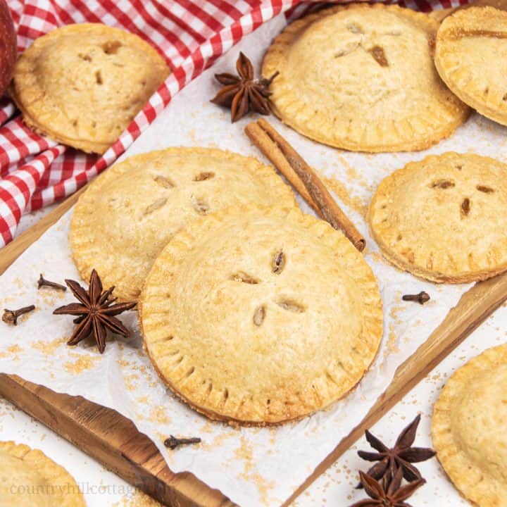 Easy apple hand pies recipe from scratch! See how to make apple hand pies with a simple vegan gluten-free cinnamon pie crust and a flavorful caramel apple filling. These simple fruit hand pies are a delicious and healthy fall baking recipe. Mini apple pies are healthy homemade food gift idea. And, this easy hand pie recipes also includes two quick shortcuts: puff pastry hand pies and apple hand pies with canned pie filling. #applehandpies #handpies #vegan #glutenfree | countryhillcottage.com