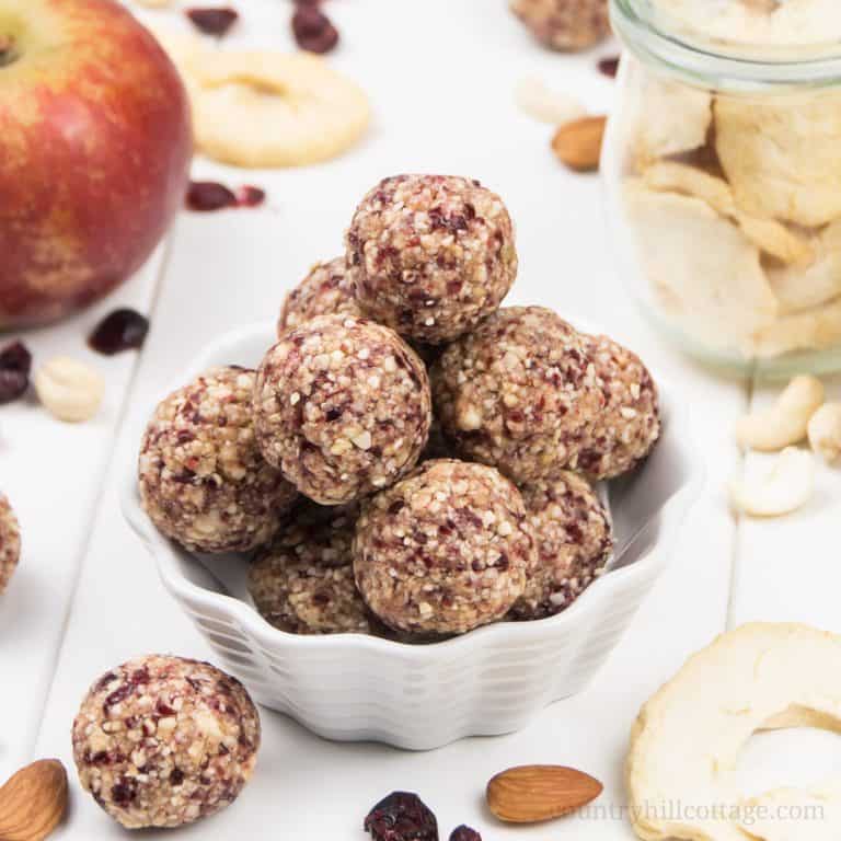 Healthy apple pie energy bites packed with dried apples, cranberries, cashew nuts, and warm spices! The easy no-bake energy balls are vegan, gluten-free, paleo-friendly and will be one of your favourite fall snack recipes. Simple grain-free vegan apple pie bites are ready in 10 minutes! A great snack for toddlers and kids, perfect healthy food gift. Without oats, grain free, no added sugar. #energyballs #blissballs #apples #applepie #paleo #vegan #glutenfree #snack | countryhillcottage.com