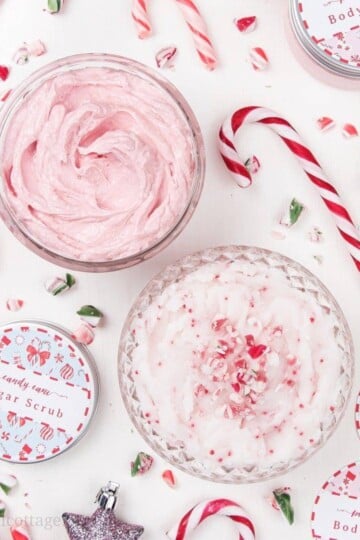 Learn how to make candy cane sugar scrub and peppermint body butter! This easy DIY whipped sugar scrub and simple homemade whipped body butter recipe are naturally fragranced with essential oils and will keep your skin moisturized throughout the holiday season. Decorated with free printable labels, the cute body scrub and natural shea body butter are also festive homemade Christmas gift ideas! #sugarscrub #bodybutter #candycane #holidaygift #printables #essential oils | countryhillcottage.com