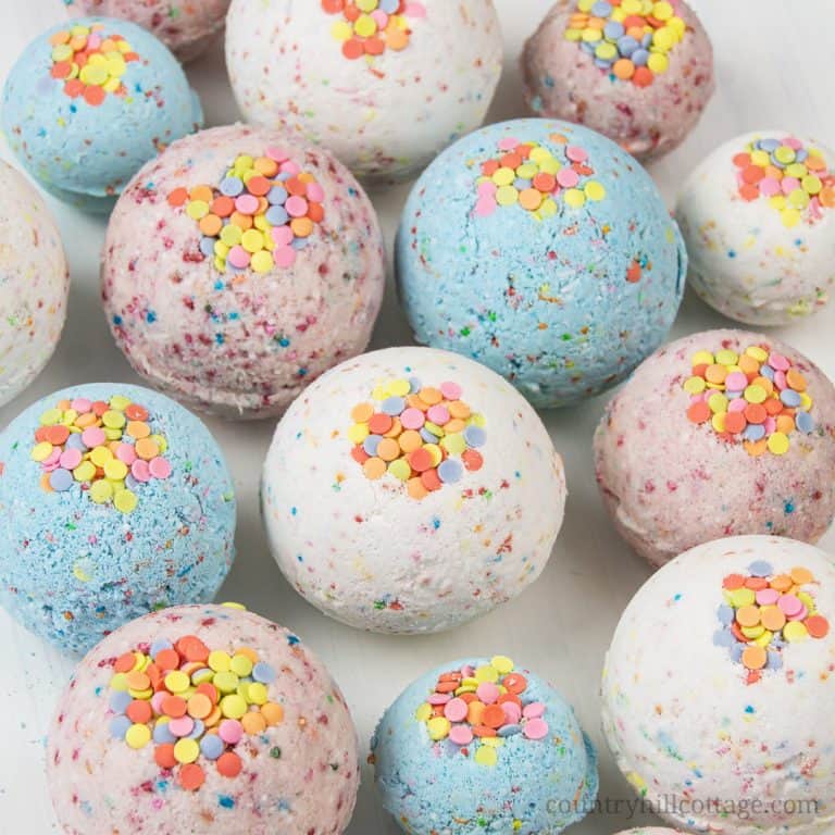 DIY bath bombs without citric acid or cream of tartar are an easy homemade bath bomb recipe for kids. These bath bombs turn a boring bath time routine into a fun experience for girls and boys. Learn how to make and customise these simple 3-ingredient funfetti bath fizzies with sprinkles, colour, and natural organic essential oils that are safe for children. Lush inspired, great gift idea. Without cornstarch, without Epsom salt, no citric acid. #bathbombs #essentialoils | countryhillcottage.com