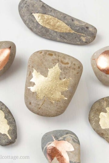Shiny DIY Gold Leaf Painted Rocks are very easy to make and a lovely pebble art idea. This quick and simple 15 minutes rock painting tutorial includes step by step instructions, tips for supplies and is excellent for beginners. The nature-inspired leaf design is beautiful fall decor and a pretty handmade craft idea to gift or sell. This rock painting inspiration is a great DIY craft project for teens and adults. #paintedrock #rockpainting #goldleaf #pebbleart #tutorial | countryhillcottage.com