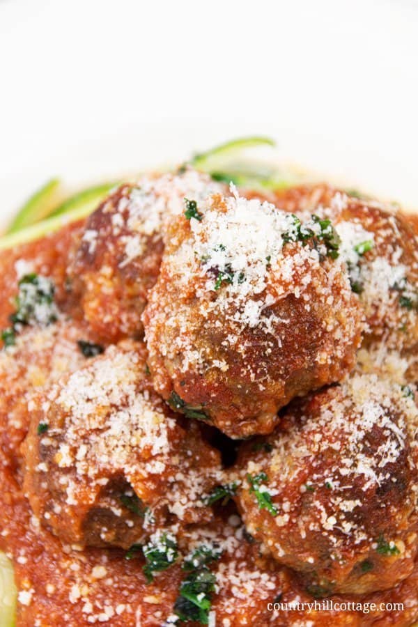 Easy homemade keto meatballs are great for kids and real family favourite! Our simple healthy homemade ketogenic meatball recipe with ground beef without breadcrumbs shows how to make gluten free Italian slow cooker meatballs in a low carb marinara sauce, perfect for the crockpot or Instant Pot. Recipe includes instructions for the stovetop to make traditional meatballs in 30 min. Spaghetti squash and meat balls are a tasty dinner & appetizer. Grain free, no breadcrumbs. | countryhillcottage.com