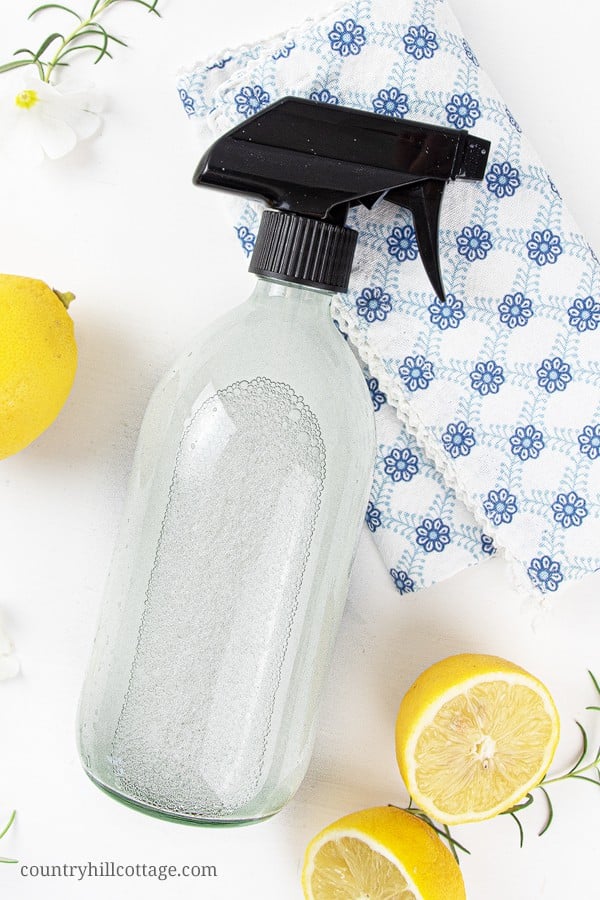 See how to make the best natural DIY all purpose cleaner recipe with essential oils! The homemade zero waste mildly disinfectant cleaning spray can be made with vodka, rubbing alcohol, Dr Bronners castile soap, Sal Suds, Dawn, Thieves, On Guard, washing soda, baking soda, hydrogen peroxide and lemon EO. Easy method for how to make your own DIY Mrs Meyers without vinegar, without borax. Safe for marble and granite, plus printable labels #cleaner #cleaning #greenliving | countryhillcottage.com