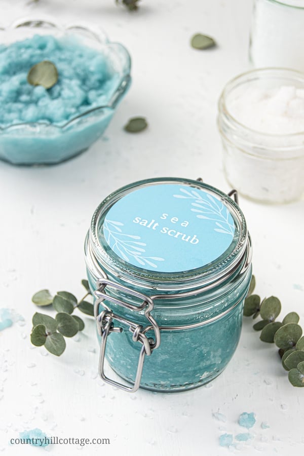 How to make easy homemade sea salt scrub for glowing skin, hands, body, foot! The best natural exfoliating DIY salt scrub recipe is made with organic moisturizing coconut oil and lemon lime essential oils has many skin care benefits and can be made with Epsom, pink Himalayan or dead sea salt. With tips for vs sugar scrub, how to store and use body scrub, packaging ideas and printable labels. Make your own Lush Ocean Salts beauty products at home. #bodyscrub #saltscrub | countryhillcottage.com