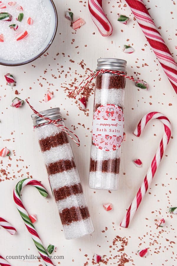 See how to make pretty DIY peppermint bath salts with Alaea red Hawaiian salt and with essential oils. Red and white candy cane bath salts are perfect to relax in the tub and make an excellent holiday gift. This homemade Christmas bath salt recipe comes with packaging ideas and free printable labels for packaging and gifting. The all-natural bath soak with peppermint essential oil is a great handmade holiday present. #bathsalt #bathsalts #essentialoils #bathsoak #gift | countryhillcottage.com