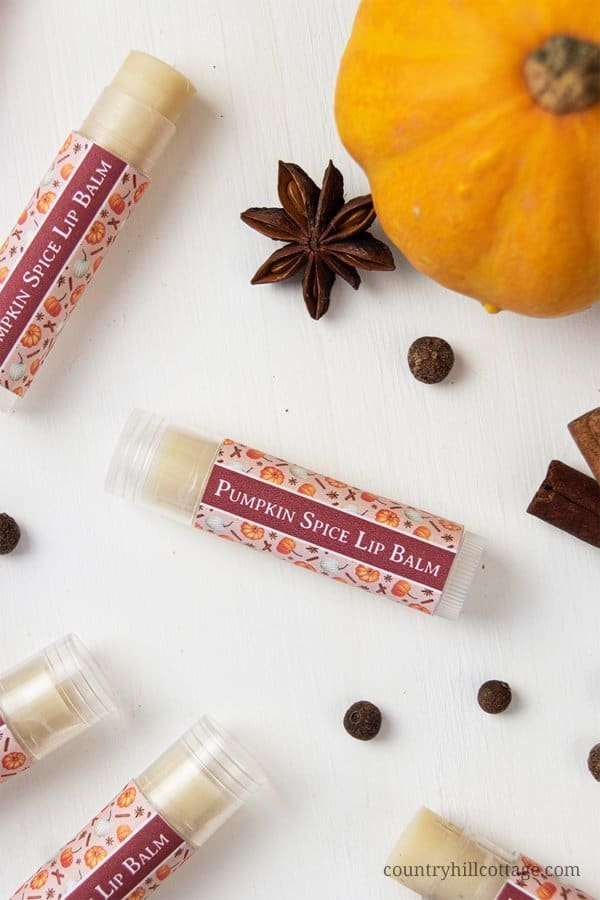 Learn how to make an easy natural DIY pumpkin spice lip balm. The moisturizing and healing lip balm recipe is made with hydrating shea butter, organic beeswax, cocoa and mango butter. The homemade Chapstick is made in the microwave with plumping cinnamon and flavored with essential oils. The step-by-step tutorial includes labels for packaging the containers or tubes. Great for kids, winter and a lovely gift for Christmas. #lipbalm #essentialoils #pumpkinspice #fall | countryhillcottage.com