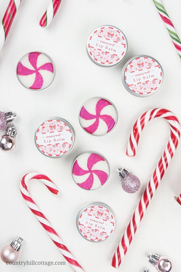 How to make the best peppermint lip balm! The easy natural DIY candy cane lip balm recipe is very moisturizing and perfect to soothe dry, cracked lips. The lip balm without beeswax is vegan and plant-based. The homemade peppermint chapstick is a cute Christmas gift and comes with free printable lip balm labels for packaging tube and containers. Made with shea butter and essential oils, great for kids. #lipbalm #peppermint #candycane #printable #essentialoils #holidays | countryhillcottage.com