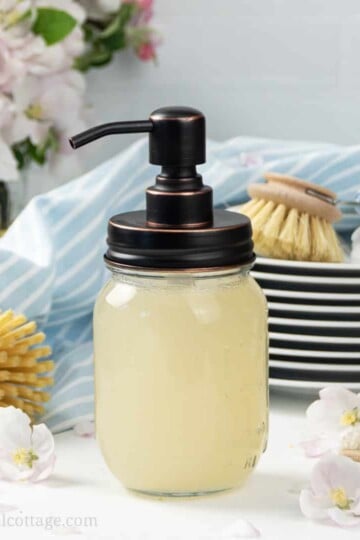 See how to make your own DIY dish wash like Dawn without castile soap or borax! The homemade foaming dish soap recipe is made with all natural ingredients, Dr Bronners Sal Suds, vinegar and Thieves essential oils. The bets simple non-toxic dish cleaner cuts through grease. The liquid detergent is also eco friendly and biodegradable, perfect for sustainable, zero waste green cleaning! Includes tips for kitchen dispenser and how to thicken. #dishsoap #greencleaning #natural | countryhillcottage