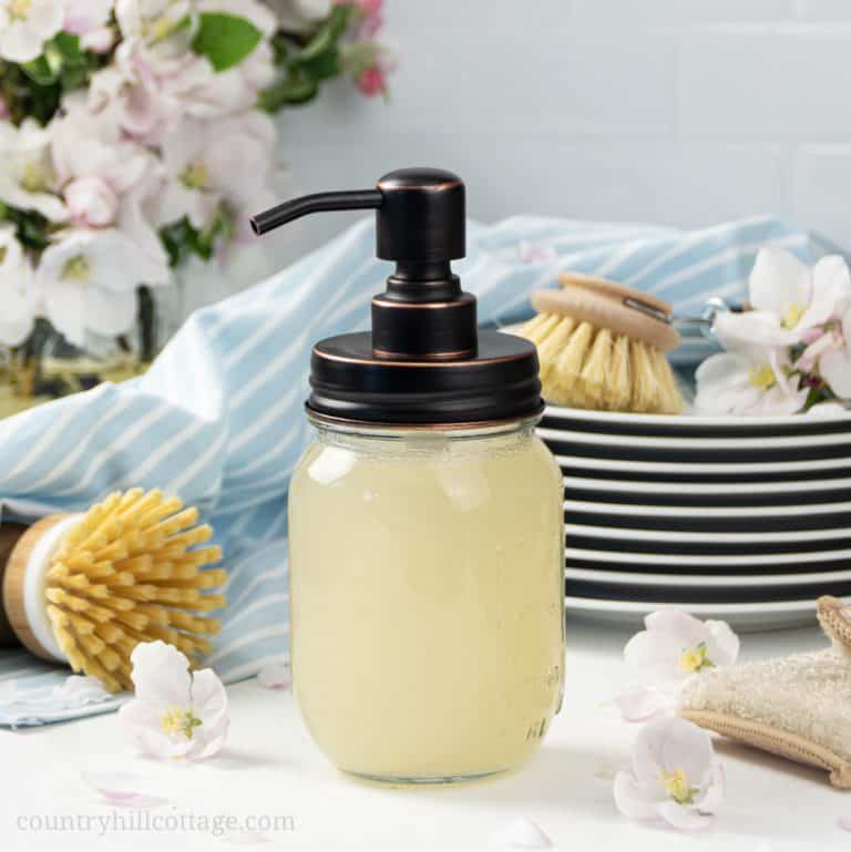 See how to make your own DIY dish wash like Dawn without castile soap or borax! The homemade foaming dish soap recipe is made with all natural ingredients, Dr Bronners Sal Suds, vinegar and Thieves essential oils. The bets simple non-toxic dish cleaner cuts through grease. The liquid detergent is also eco friendly and biodegradable, perfect for sustainable, zero waste green cleaning! Includes tips for kitchen dispenser and how to thicken. #dishsoap #greencleaning #natural | countryhillcottage