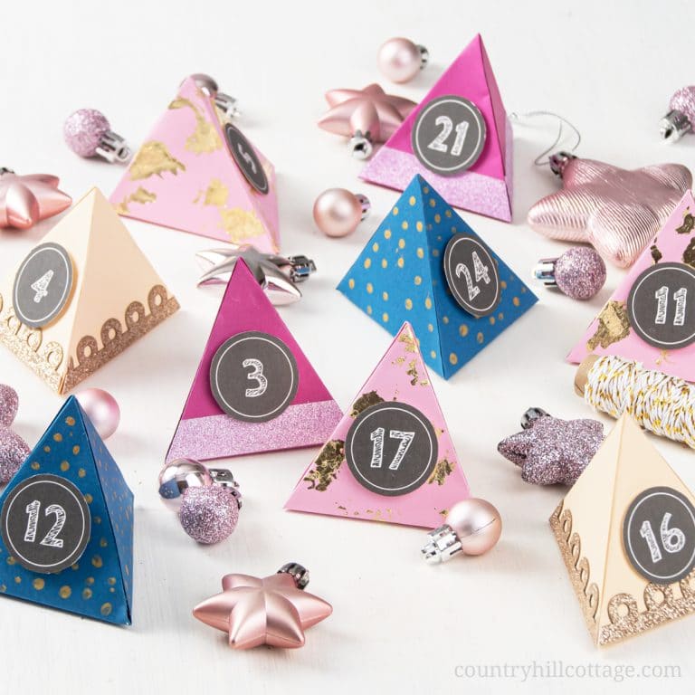 Make your own easy DIY paper advent calendar with free printable templates for the boxes numbers! This homemade advent calendar is a fun Christmas papercraft and holiday gift for kids, adults, husband, boyfriend, teens, children. The tutorial includes handmade advent calendar fillers ideas like chocolate and beauty items for what to put in. The design cane me modern or traditional and comes with PDF and SVG templates. #adventcalendar #papercrafts #DIY #holidaycrafts | countryhillcottage.com