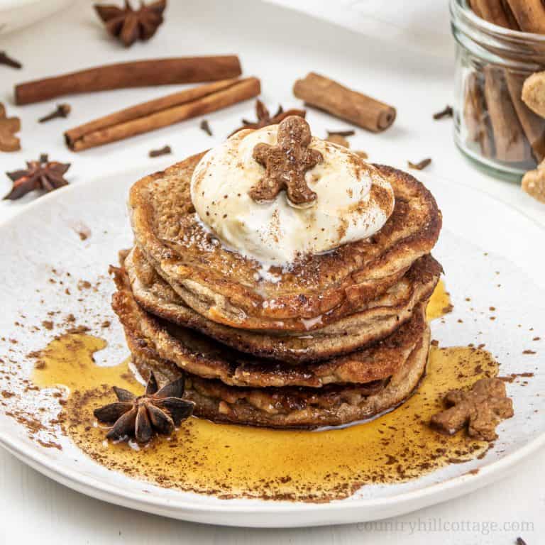 See how to make fluffy gingerbread pancakes! The easy holiday spice pancakes recipe is quick to whip up and perfect for Christmas morning breakfast and holiday brunch. Made with warming gingerbread spices, this healthy pancake recipe with almond flour is gluten-free, dairy-free, refined sugar-free and suitable for paleo. Plus, the healthy breakfast recipe takes only 30 minutes from start to finish. Great for kids, made without molasses. #pancakes #gingerbread #breakfast | countryhillcottage.com