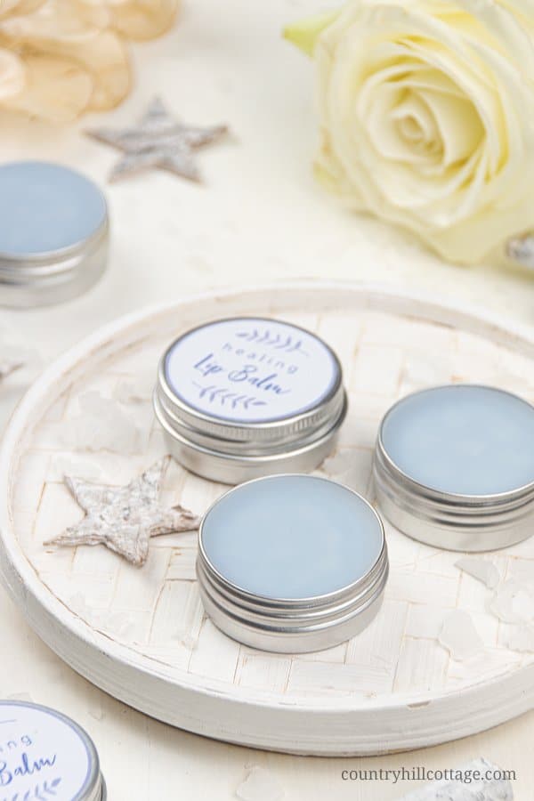 See how to make a simple healing lip balm recipe to care for chapped, peeling lips! This homemade natural lip balm for dry lips with organic coconut oil, hydrating castor oil and hemp seed oil is ready in minutes. This easy DIY lip balm without beeswax is a great moisturizing lip balm for winter and tinted with shimmer mica. The step-by-step tutorial includes cute labels for packaging containers. #skincare #vegan #lipbalm #beautydiy #essentialoils #coconutoil #winter | countryhillcottage.com