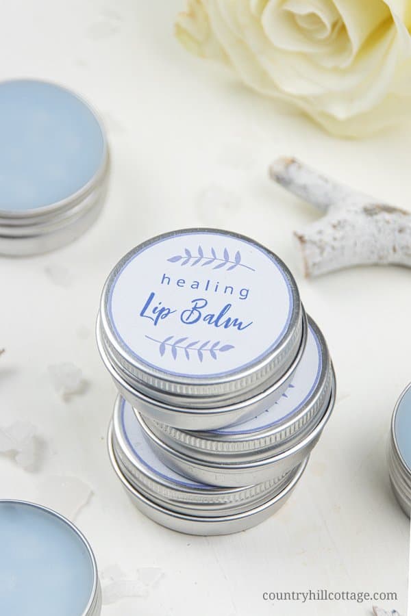 See how to make a simple healing lip balm recipe to care for chapped, peeling lips! This homemade natural lip balm for dry lips with organic coconut oil, hydrating castor oil and hemp seed oil is ready in minutes. This easy DIY lip balm without beeswax is a great moisturizing lip balm for winter and tinted with shimmer mica. The step-by-step tutorial includes cute labels for packaging containers. #skincare #vegan #lipbalm #beautydiy #essentialoils #coconutoil #winter | countryhillcottage.com