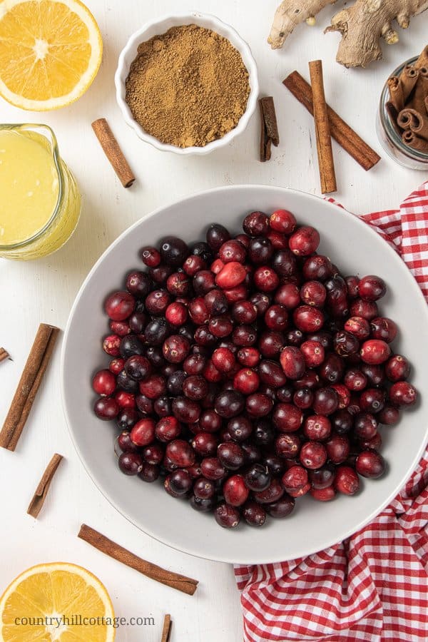 Learn how to make healthy cranberry sauce as holiday side dish for Thanksgiving and Christmas. You only need 15 min to make paleo cranberry sauce. The easy cranberry sauce with orange juice and coconut sugar is refined sugar free, vegan and gluten-free. The simple homemade recipe starts with 3 ingredients, spices, maple syrup, apple juice, port and other liquors can be added. Includes ideas for uses for leftovers. #cranberries #cranberrysauce #paleo #vegan #glutenfree | countryhillcottage.com
