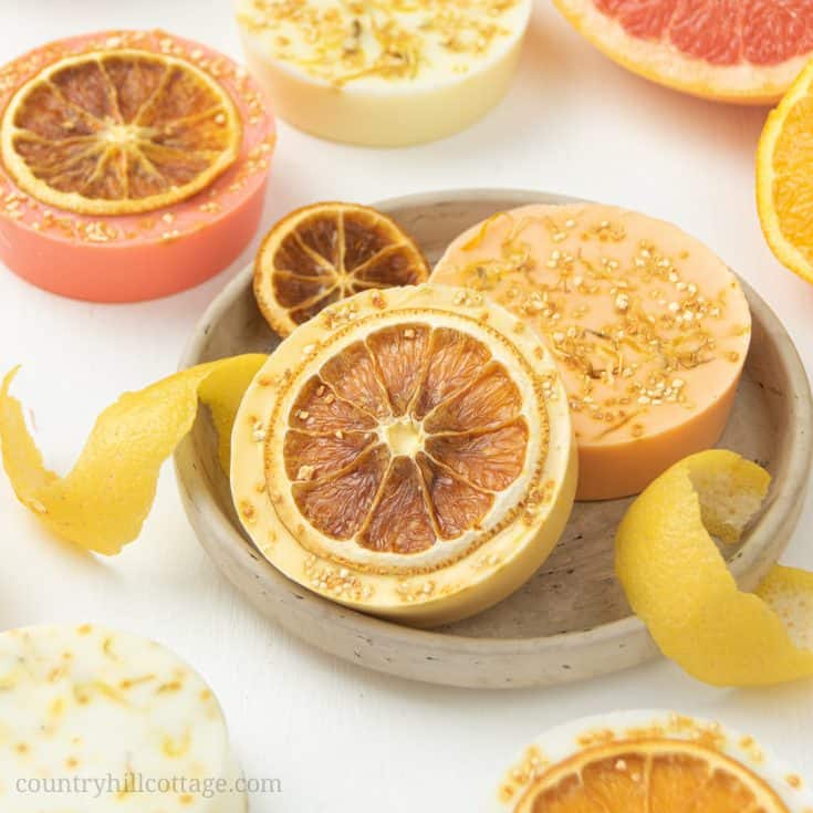 This homemade citrus soap recipe has an uplifting scent, rich lather and many skin care benefits. Natural DIY lemon soap bars are made with goat milk, shea butter or glycerin melt and pour base and essential oils - ideal for soap making for beginners! The handmade tutorial shows how to make melt and pour soap, gives different citrus essential oil blends for soap, tips for molds, packaging ideas and more recipes inspiration. Cute hand soap teacher gift! #soap #soapmaking | countryhillcottage.com